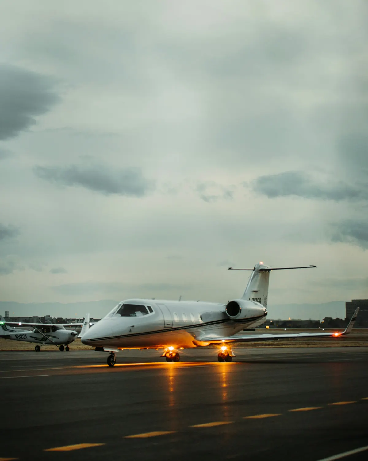 Business jet on the ramp under a moody evening sky