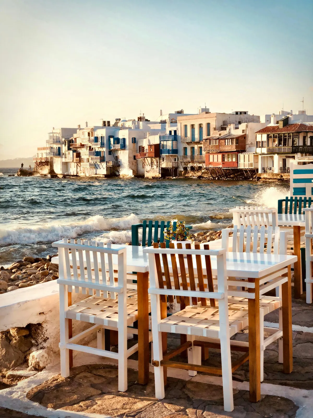 Painted chairs on a seaside terrace in Little Venice, Mykonos