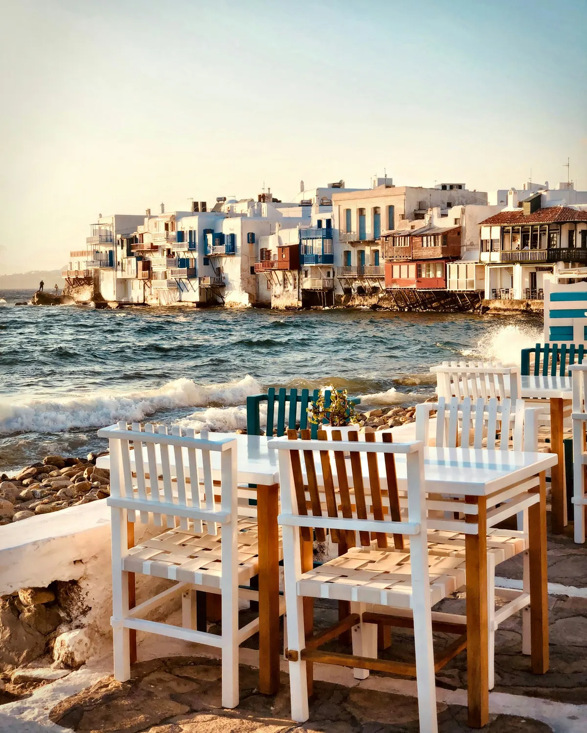 Painted wooden chairs on a seaside terrace in Little Venice