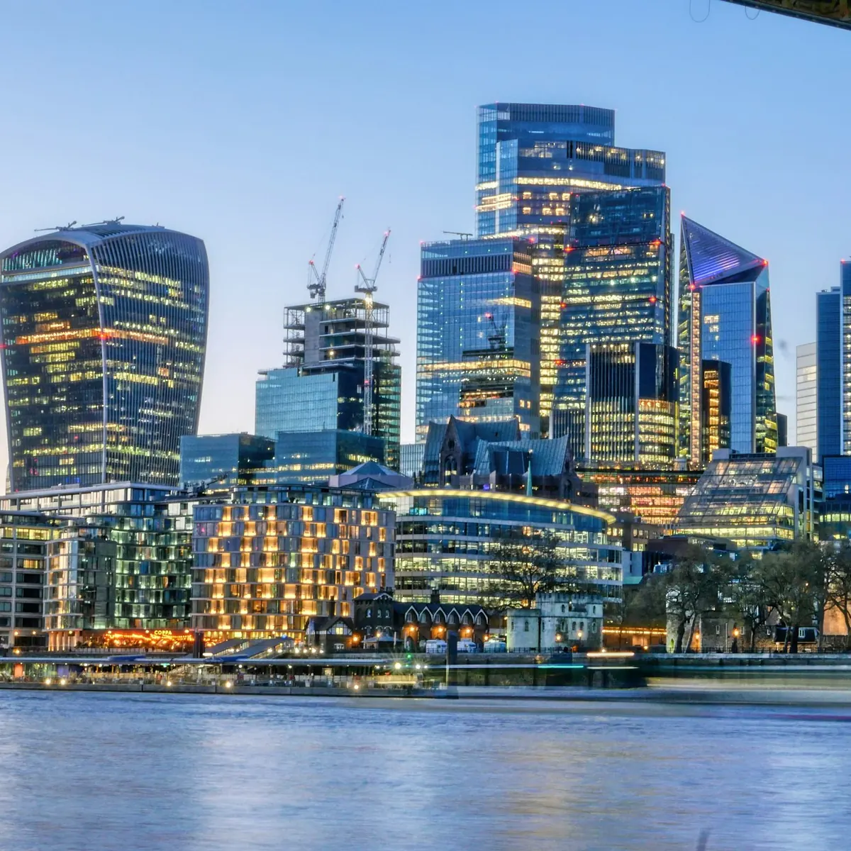 The City of London skyline across the Thames at dusk