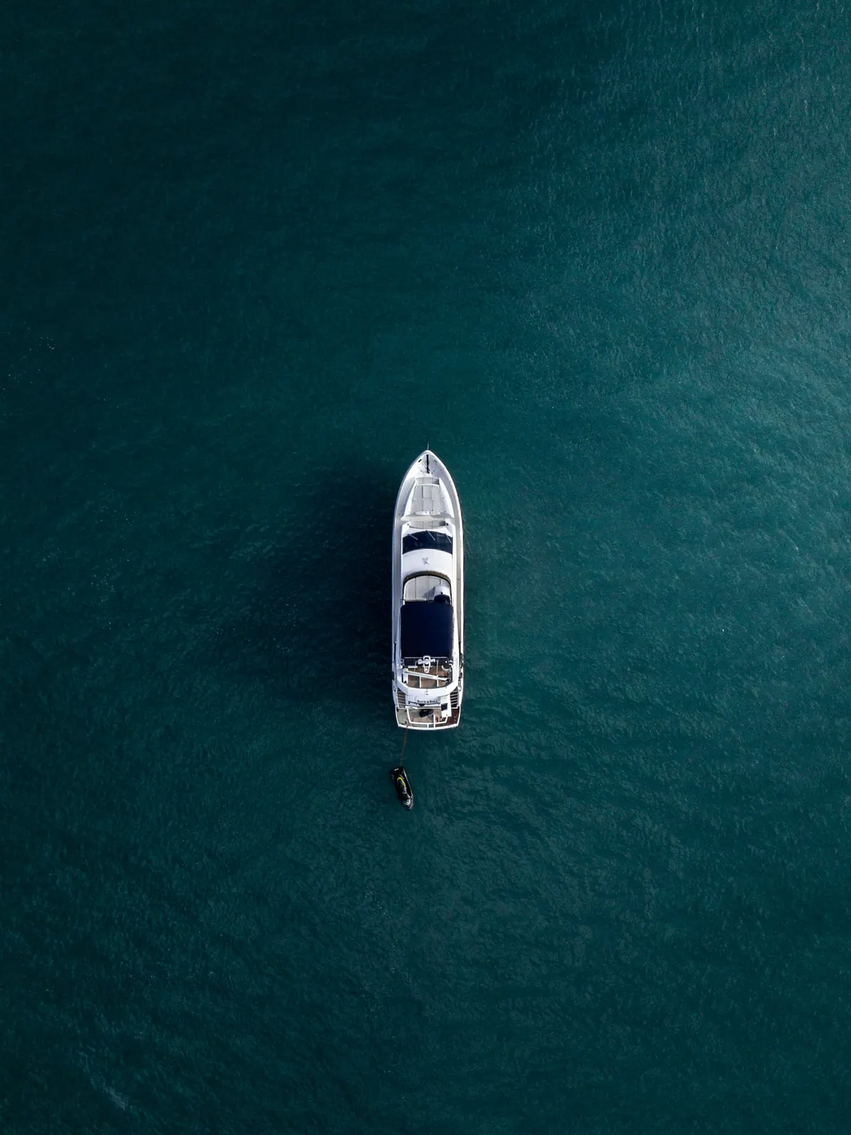 Motor yacht seen from above on deep blue water